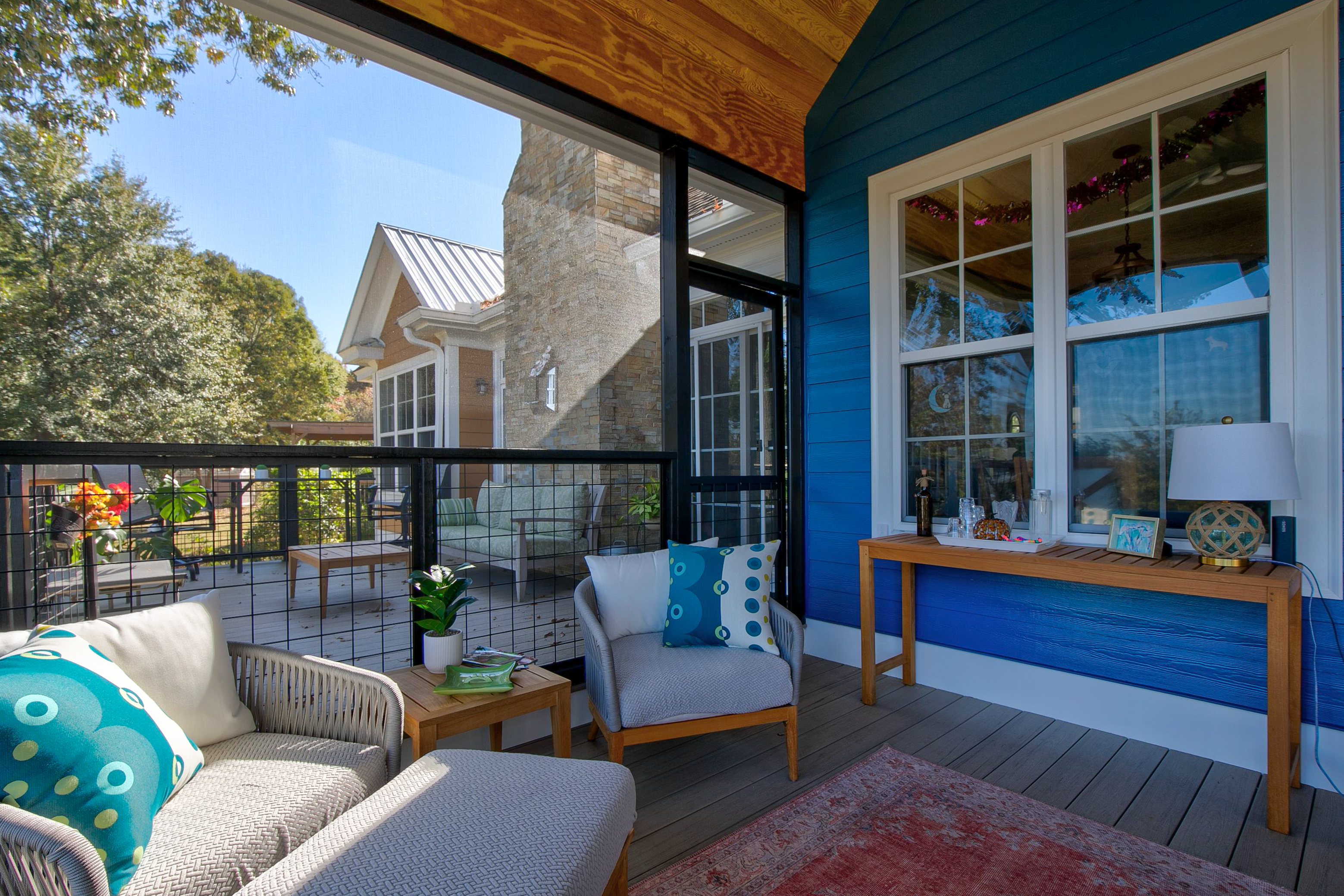 View of the inside of a screened in back porch facing the house. 