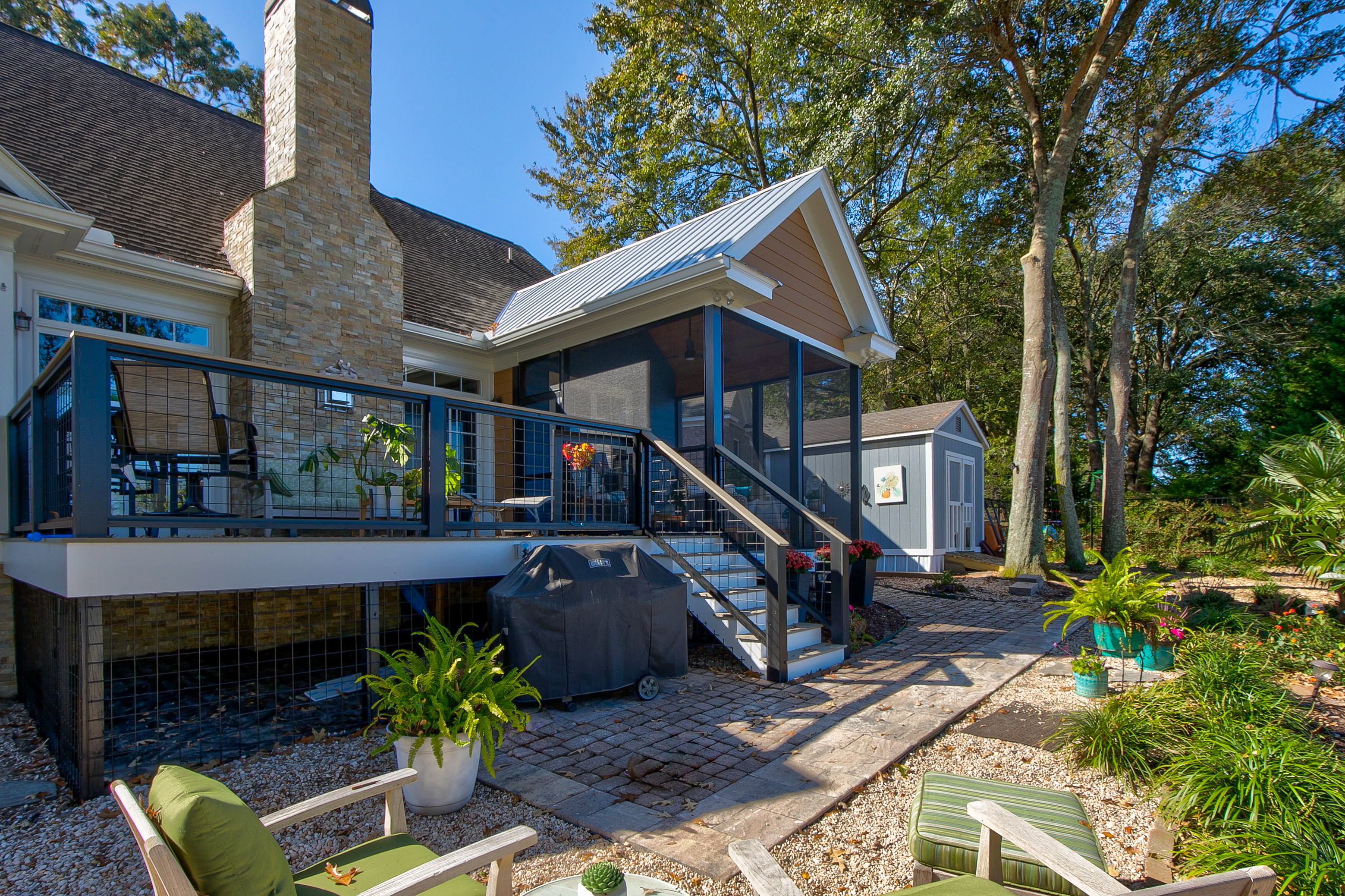 View of back porch with a screened in area from the back yard. 