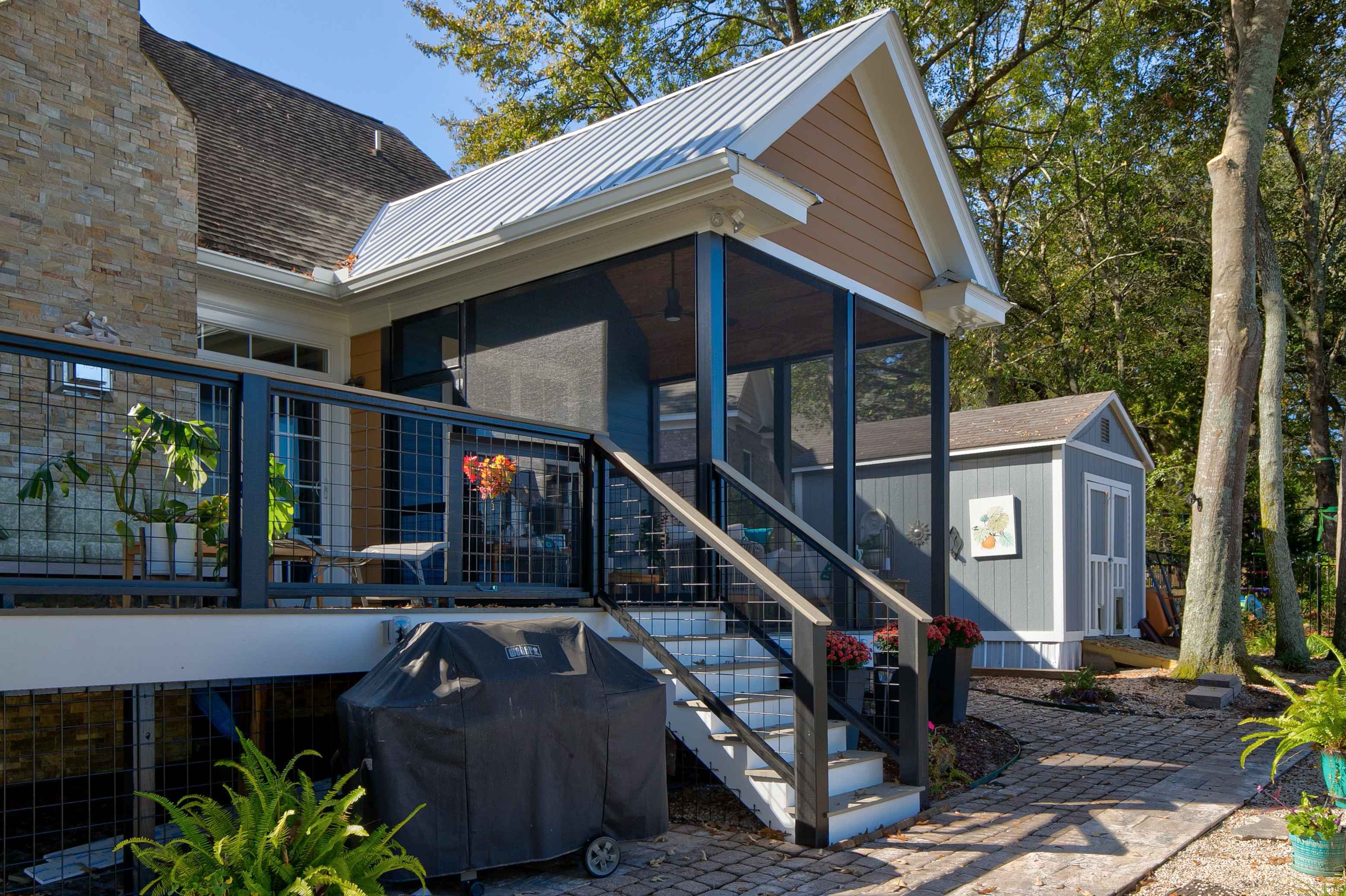 View of screened in back porch from the back yard. 