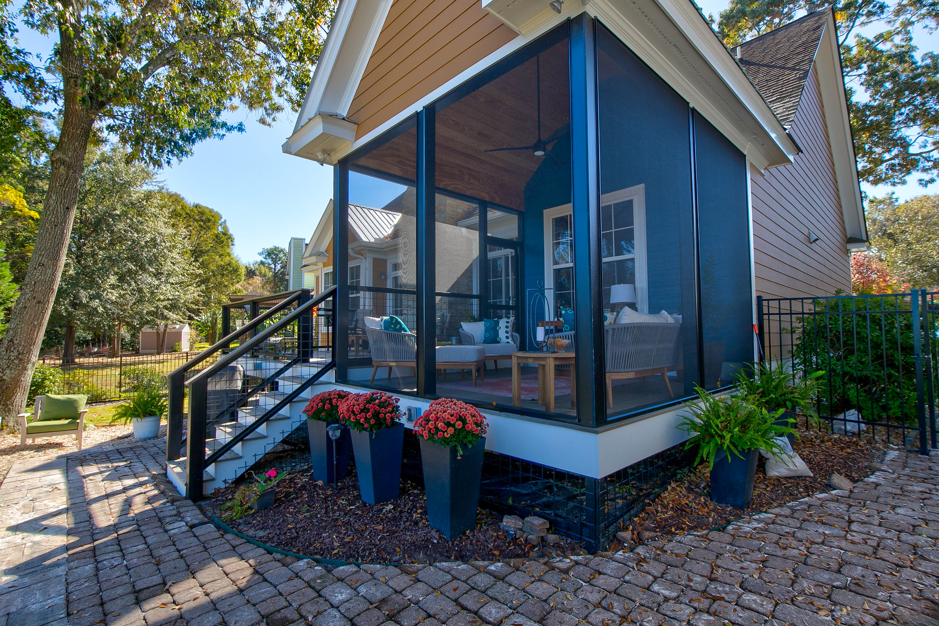 View of screened in back porch from the side. 