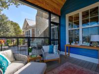View of the inside of a screened in back porch facing the house.