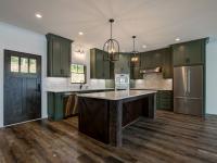 Custom Rafter B kitchen featuring stone countertops and stainless steel appliances in a lakeside home