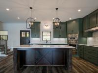 Custom Rafter B kitchen featuring stone countertops and stainless steel appliances in a lakeside home
