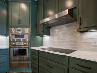 Custom Rafter B kitchen featuring stone countertops and stainless steel appliances in a lakeside home