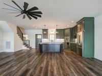 Custom Rafter B kitchen featuring stone countertops and stainless steel appliances in a lakeside home
