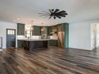 Custom Rafter B kitchen featuring stone countertops and stainless steel appliances in a lakeside home