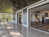 Large sliding glass doors on back porch of Rafter B custom lakeside home