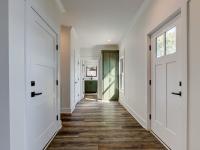 Interior hallway with built-in cabinetry and wooden floors