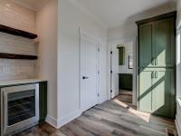 Interior hallway with built-in cabinetry and wooden floors and beverage cooler