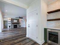 Interior hallway with built-in cabinetry and wooden floors and beverage cooler