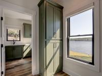 Interior hallway with built-in cabinetry and wooden floors
