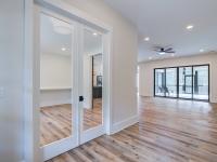 Entry with white walls and wooden floors