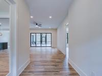 Entry with white walls and wooden floors