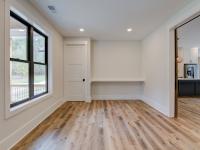 Room with white walls and wooden floors - Rafter B Construction custom home