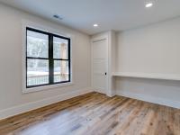 Room with white walls and wooden floors - Rafter B Construction custom home
