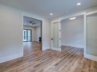 Room with white walls and wooden floors - Rafter B Construction custom home