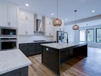 Open concept kitchen with white cabinets and large island - Rafter B Construction custom home