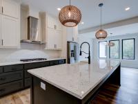 Open concept kitchen with white cabinets and large island - Rafter B Construction custom home