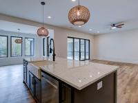 Open concept kitchen with white cabinets and large island - Rafter B Construction custom home