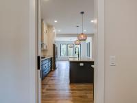 Open concept kitchen with white cabinets and large island - Rafter B Construction custom home