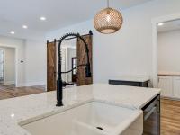 Open concept kitchen with white cabinets and large island - Rafter B Construction custom home
