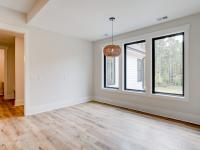 Dining room with wood floors, white walls and large windows