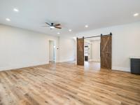 Room with wood floors, white walls and large windows