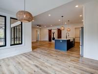 Dining room with wood floors, white walls and large windows