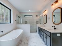Ensuite bathroom with tub, double sinks and shower
