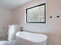 Ensuite bathroom with tub, double sinks and shower
