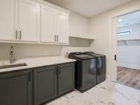 Laundry room with washer, dryer, and built in cabinets
