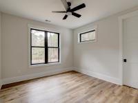 Room with wood floors, white walls and ceiling fan