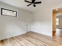 Room with wood floors, white walls and ceiling fan