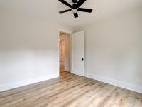 Room with wood floors, white walls and ceiling fan