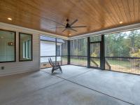 Screened back porch with wood ceiling and ceiling fan