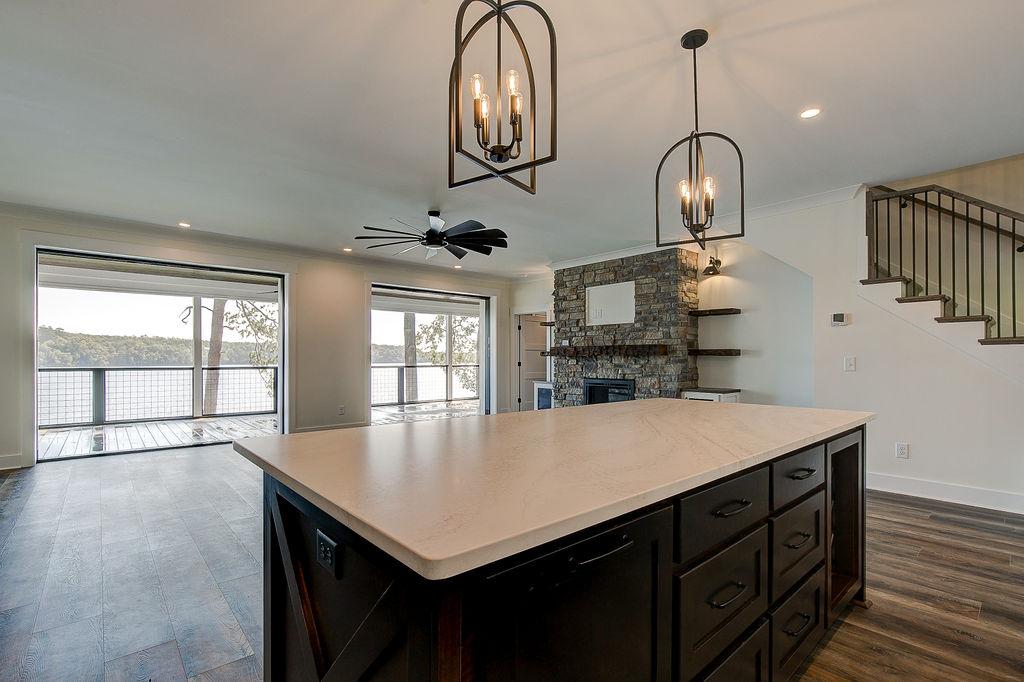 Custom Rafter B kitchen featuring stone countertops and stainless steel appliances in a lakeside home