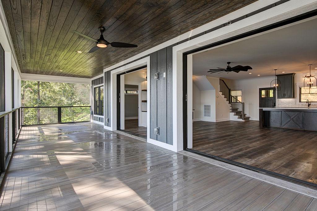 Large sliding glass doors on back porch of Rafter B custom lakeside home