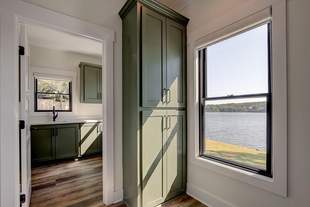 Interior hallway with built-in cabinetry and wooden floors