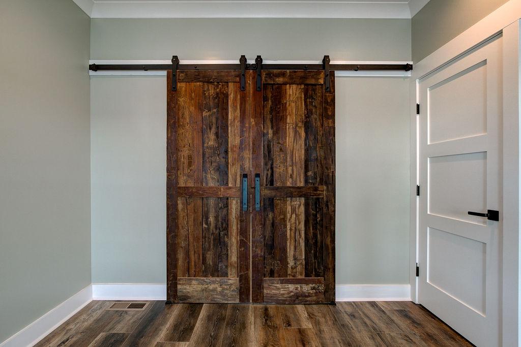 Interior room with wooden floors and rustic farmhouse sliding doors