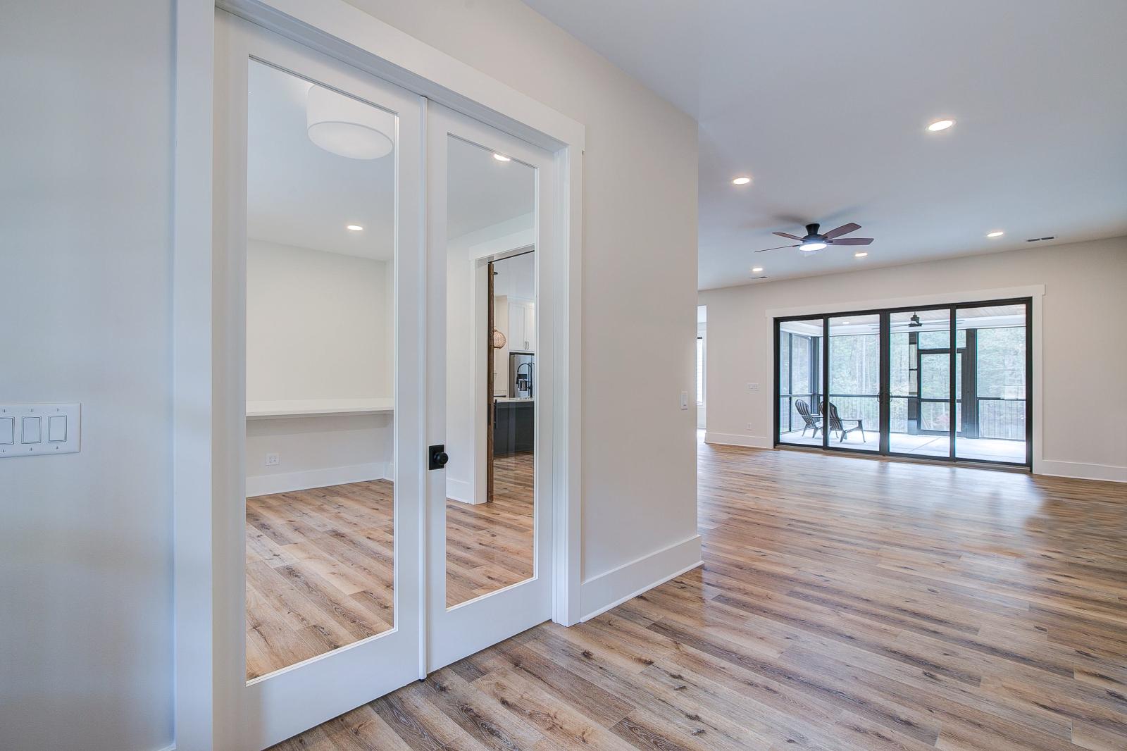 Entry with white walls and wooden floors