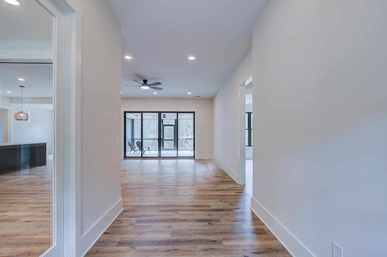 Entry with white walls and wooden floors