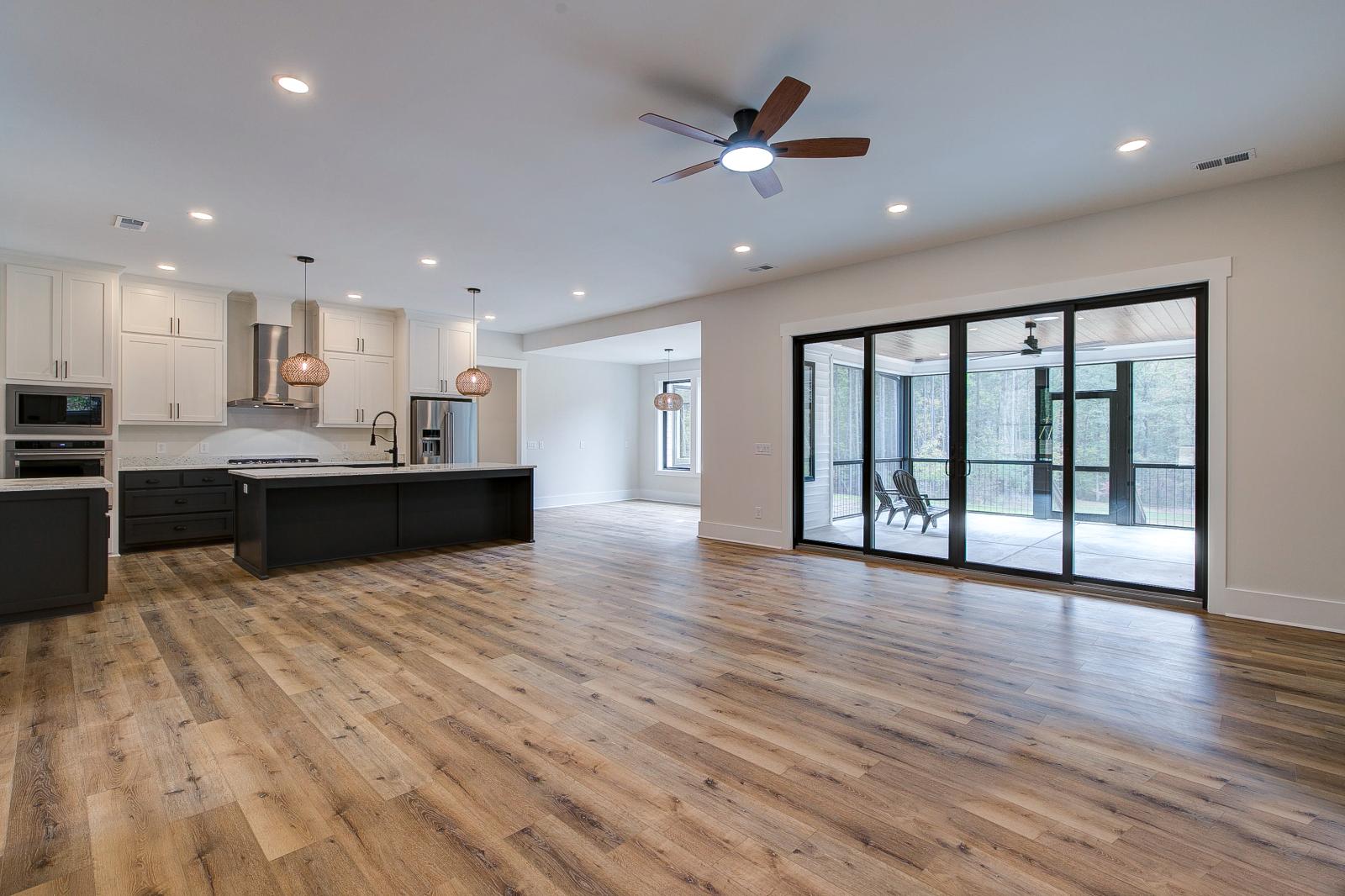 Room with white walls and wooden floors - Rafter B Construction custom home