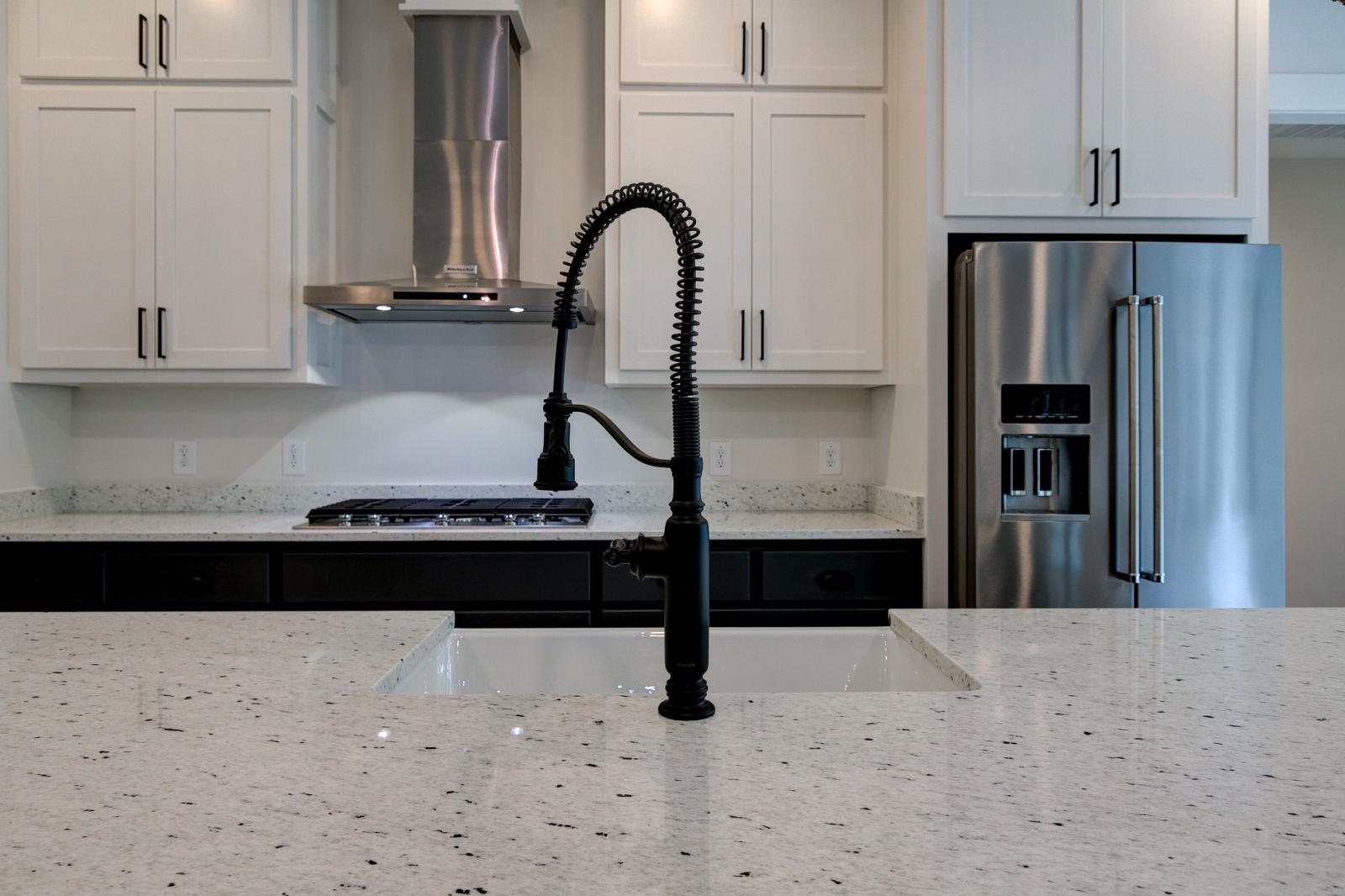 Close up of sink and marble countertops