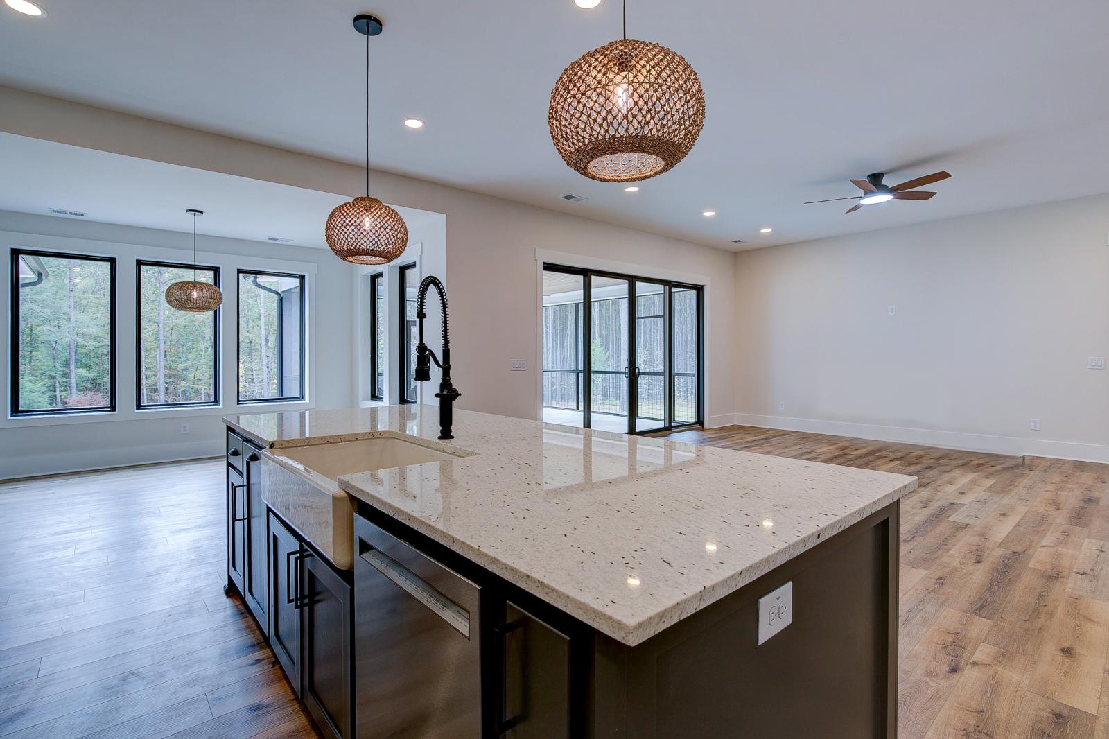 Open concept kitchen with white cabinets and large island - Rafter B Construction custom home