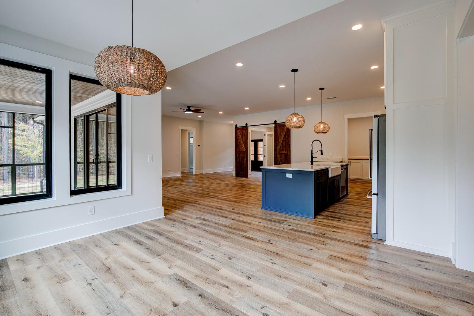 Dining room with wood floors, white walls and large windows