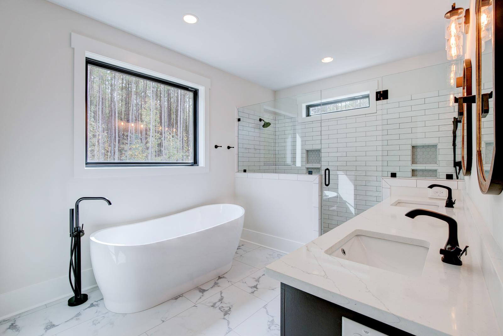 Ensuite bathroom with tub, double sinks and shower