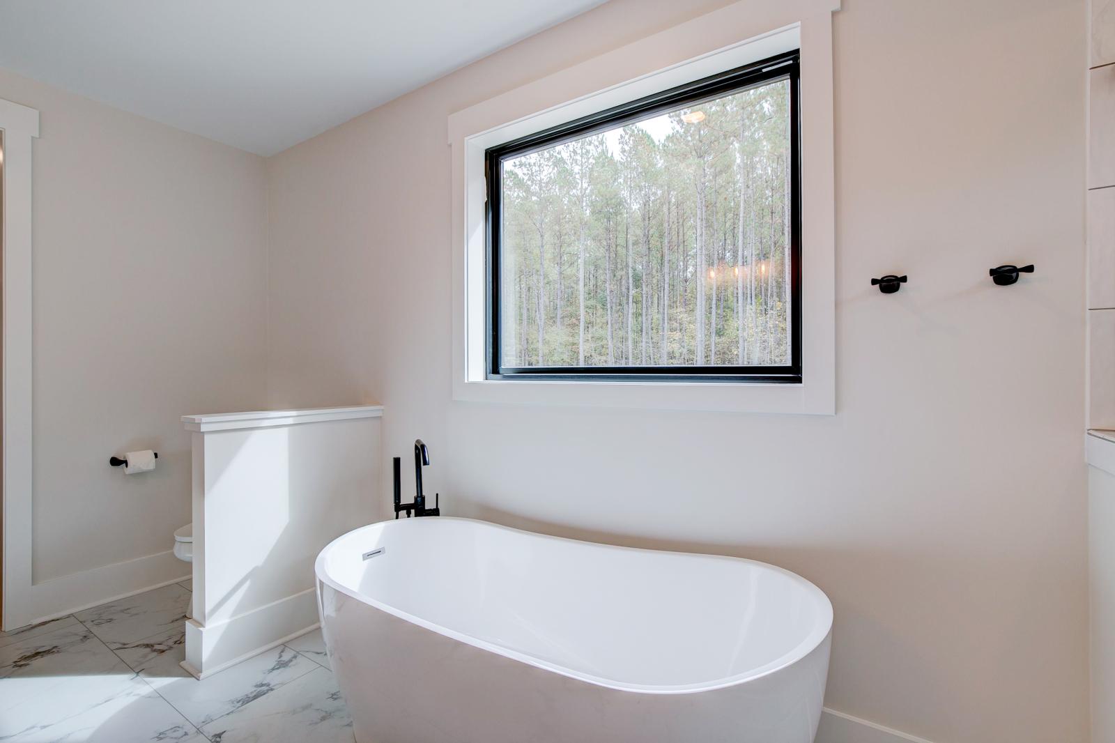 Ensuite bathroom with tub, double sinks and shower