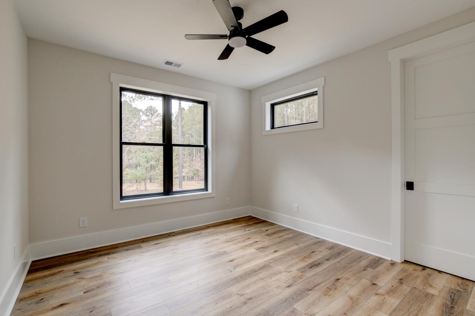 Room with wood floors, white walls and ceiling fan