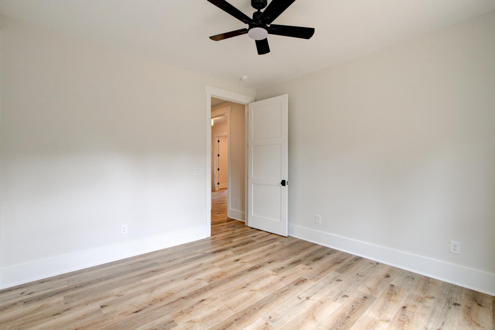 Room with wood floors, white walls and ceiling fan