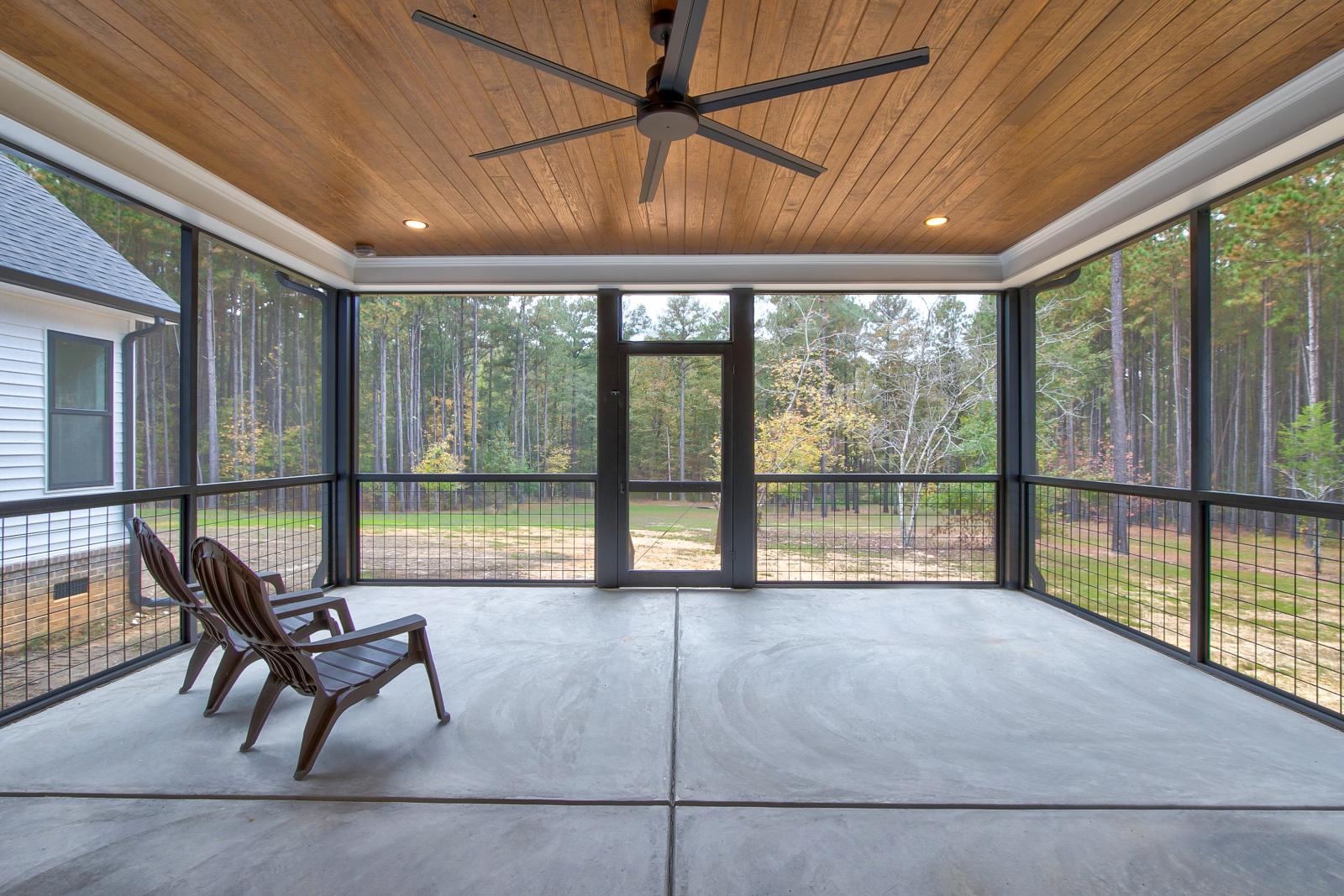 Screened back porch with wood ceiling and ceiling fan